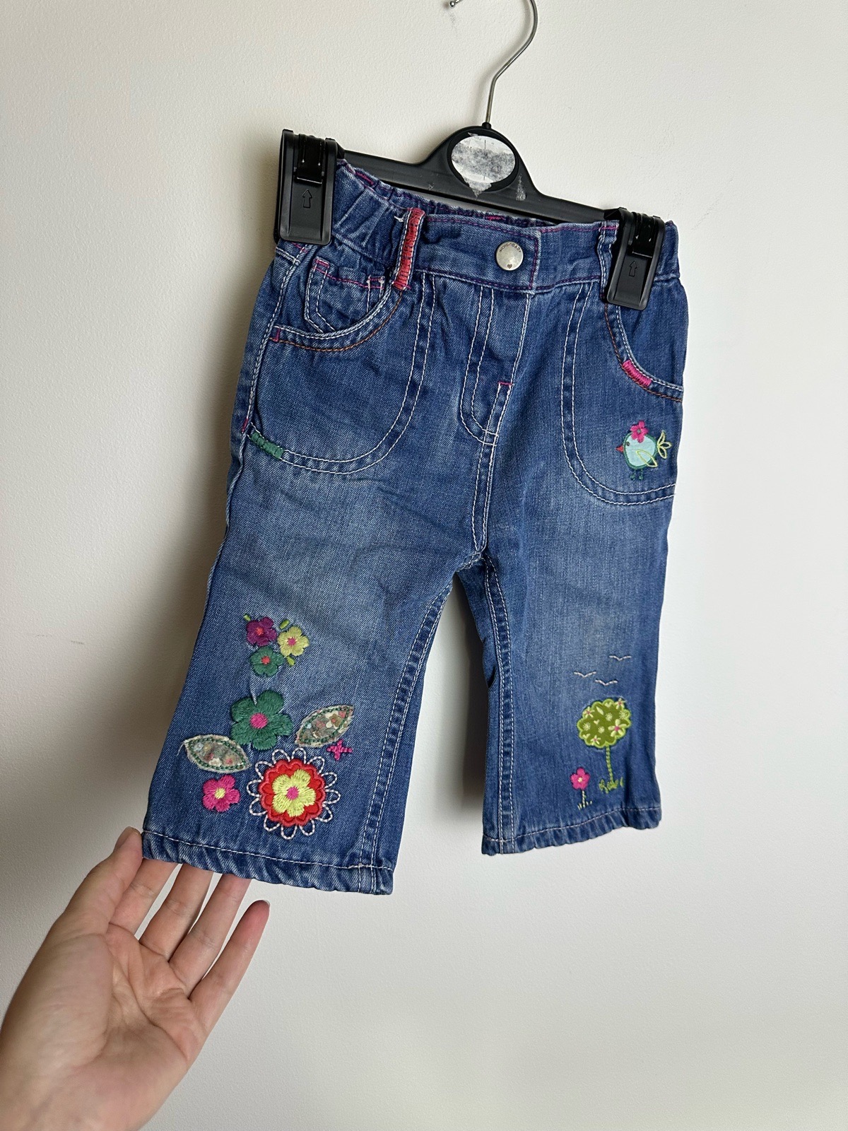 Marks & Spencer baby girls blue denim jeans, size 6–9 months.  Cute colourful embroidered details in