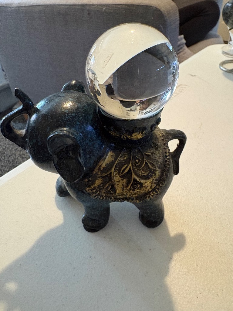 A beautiful elephant holder with glass sphere