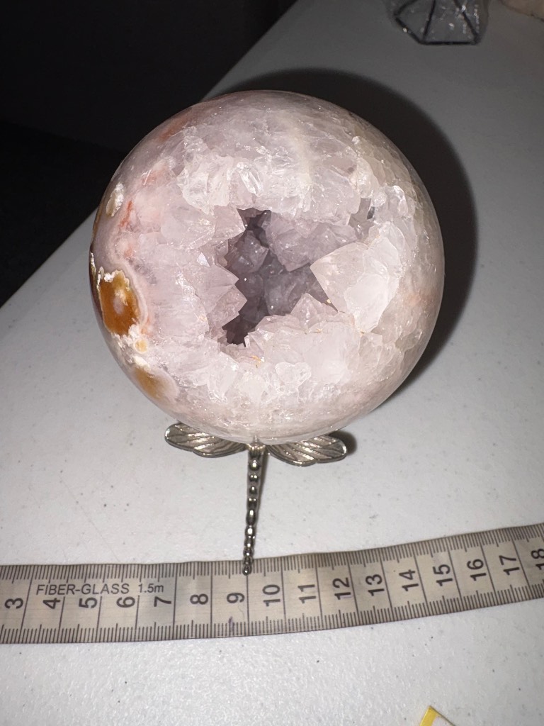 A large pink amethyst sphere with natural Druzy and clusters inside