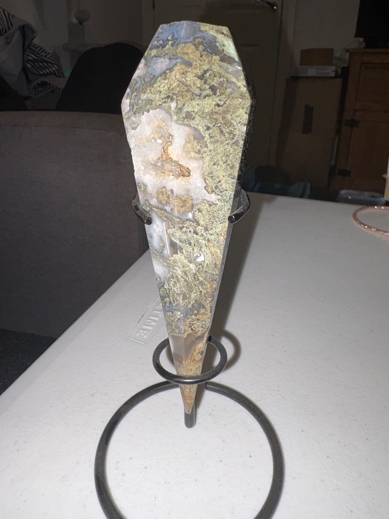 Moss agate wand on a black stand with natural Druzy