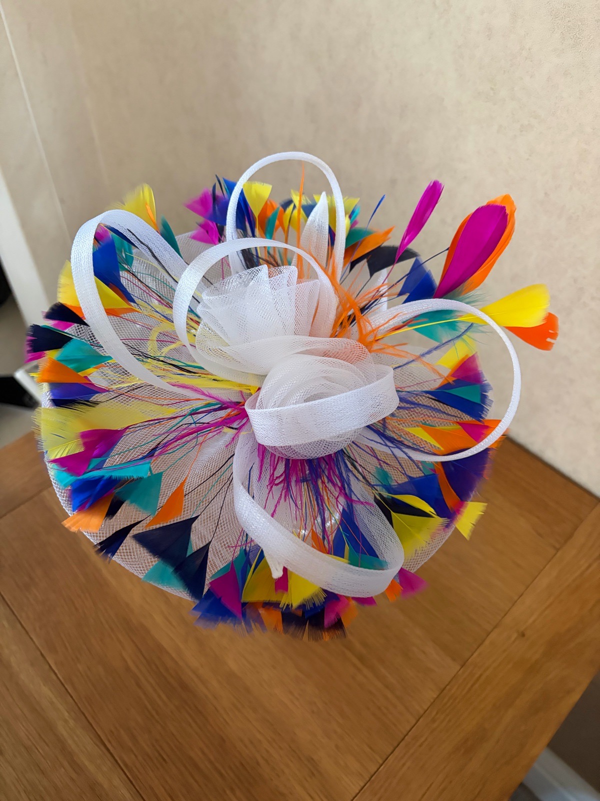 White fascinator with multiple coloured feathers - New