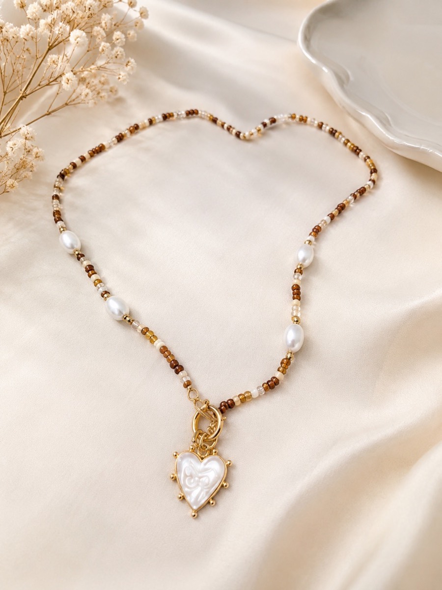 Stunning beaded heart detail necklace in browns and creams, with mother of pearl like heart