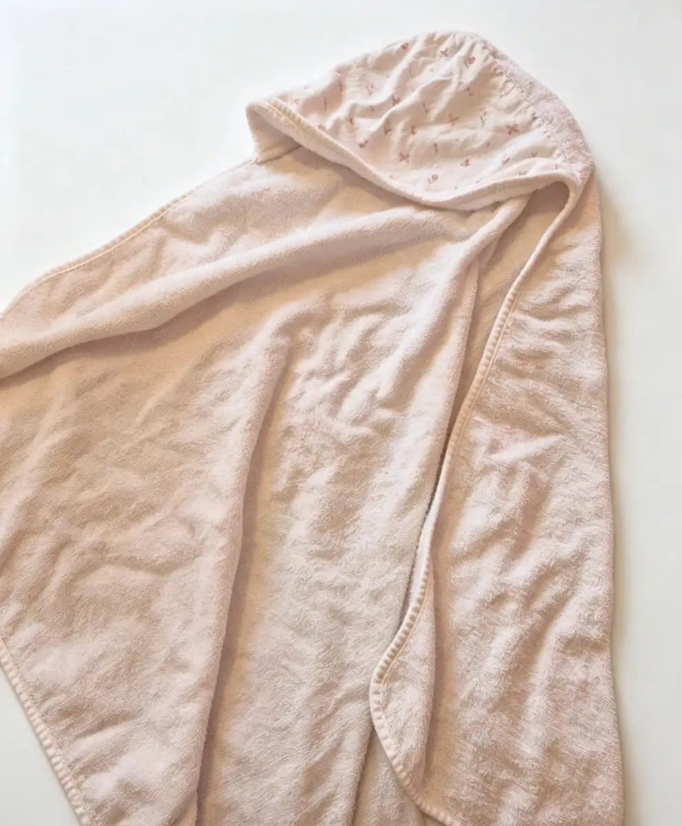 Cute pale pink/ white hooded baby towel with lovely floral design on inside of the hood. One size