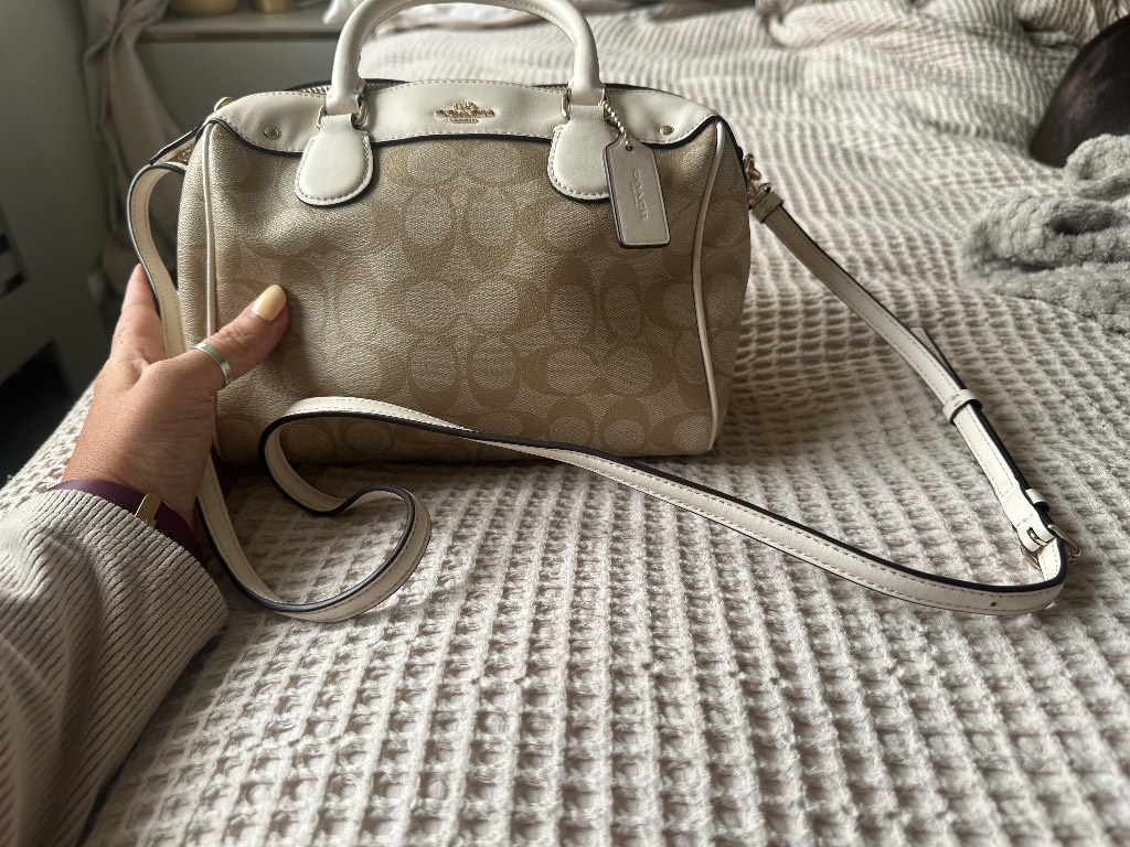 This Beige Coach Mini Rowan Crossbody Bag In Signature Canvas Features Leather