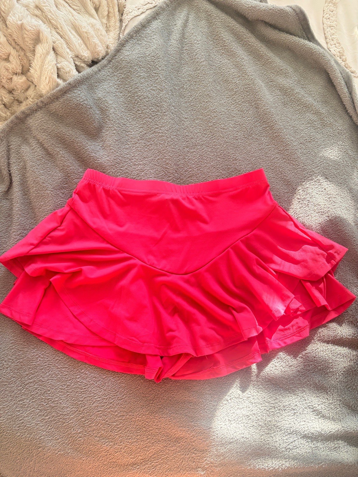 hot pink ruffled mini sports skort from SHEIN, featuring a high elastic waistband, layered frills, a