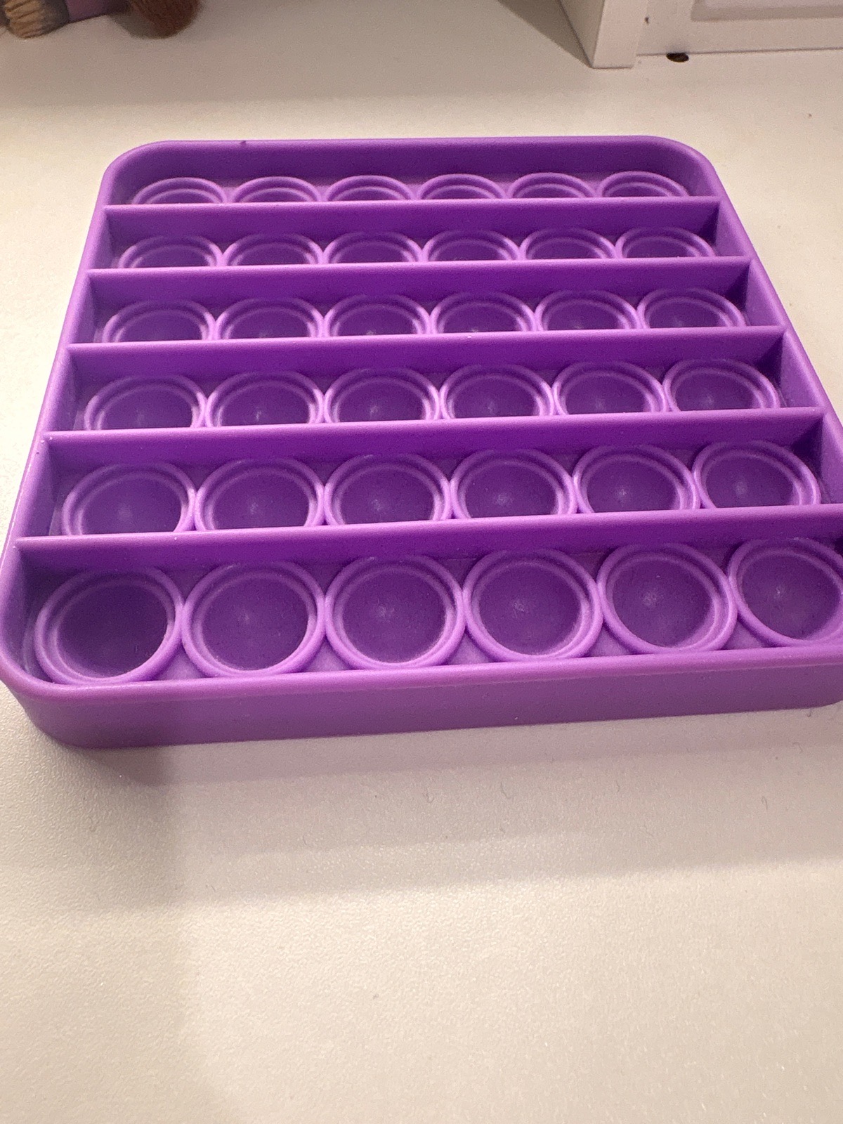 purple square fidget toy designed for sensory relief.