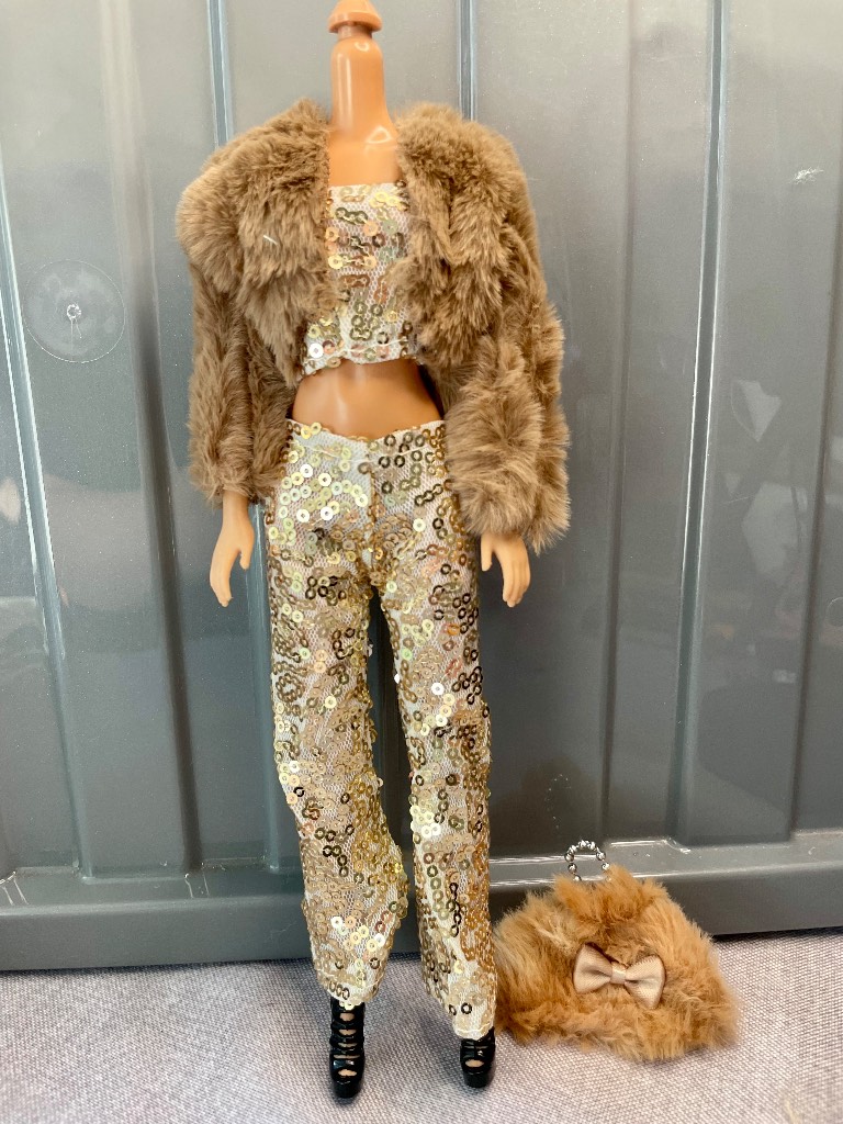 Barbie doll gold sequin top and trousers, silver earrings, shoes, faux fur coat and bag