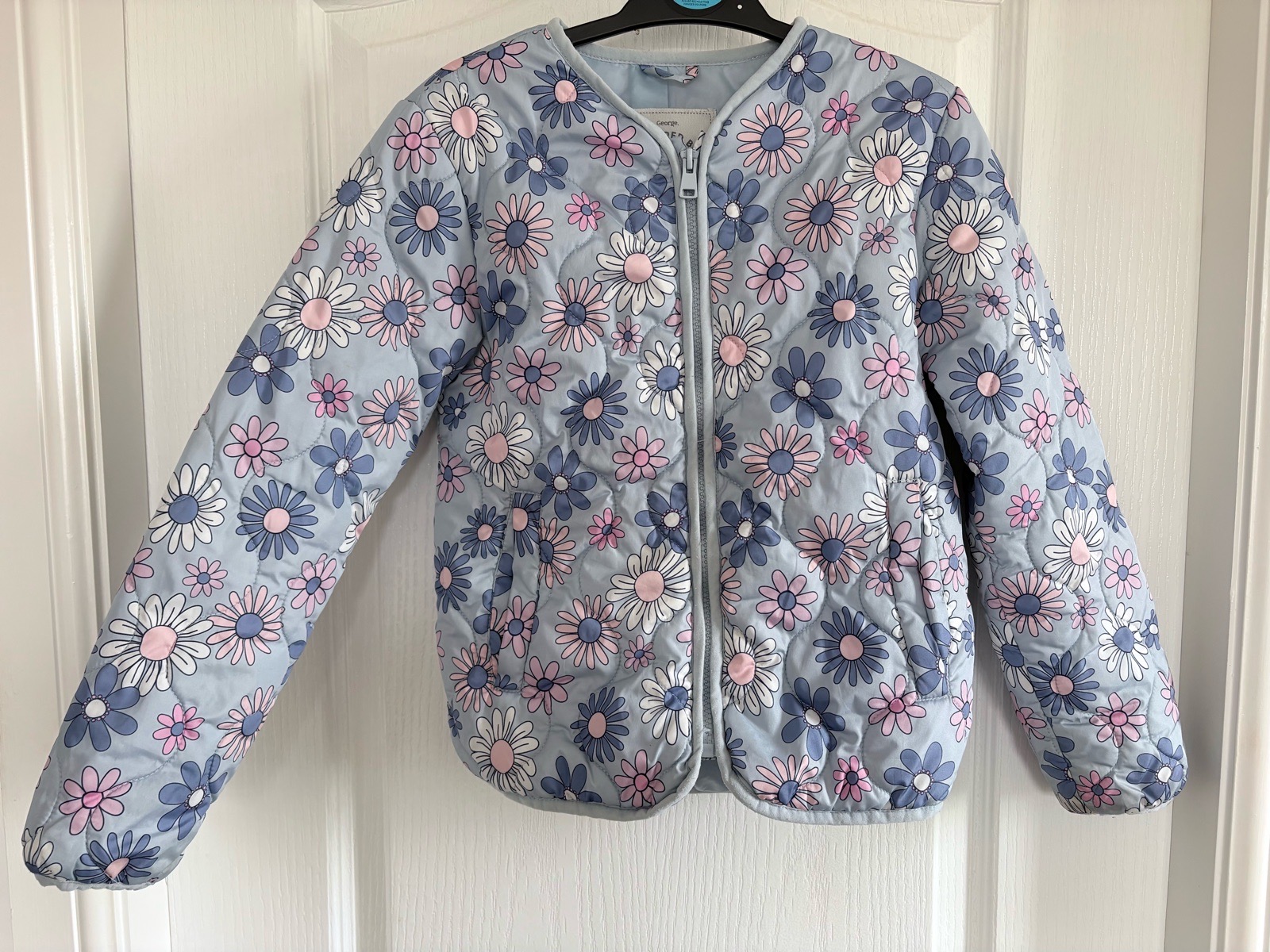 Girls blue floral, quilted jacket/coat.  8-9 years