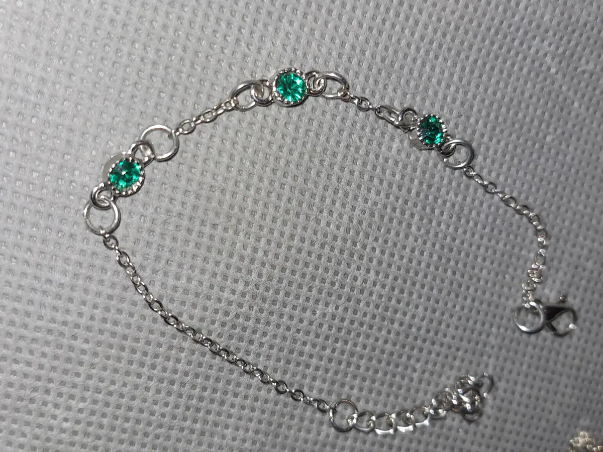 silver tone bracelet withgreen stones