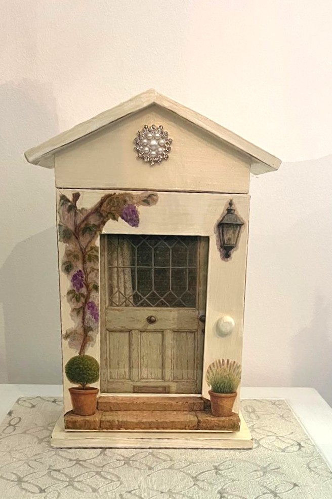 A Rustic Style Wooden Storage Box Fashioned to Look Like a Small Country House