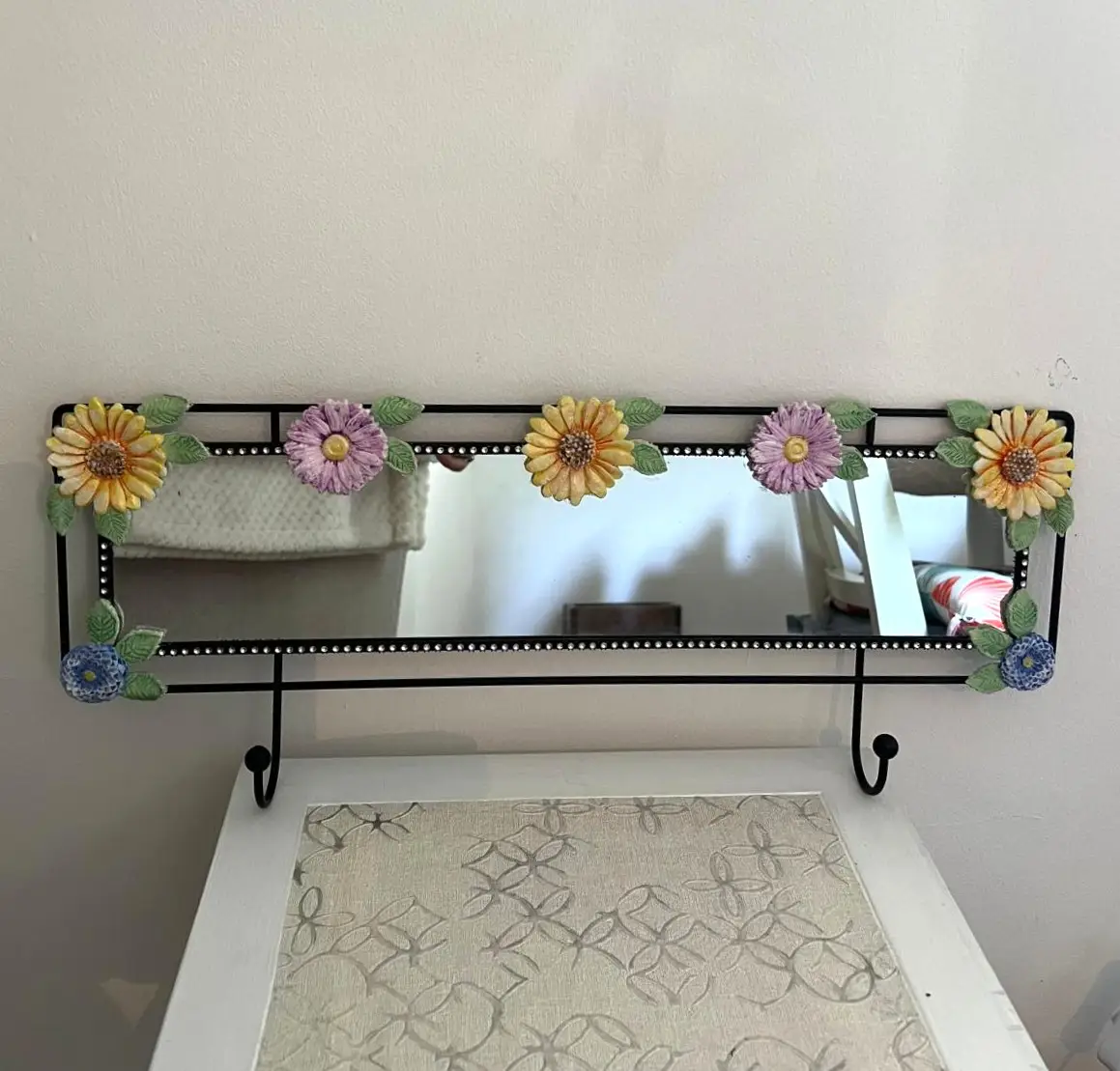 Mirrored Coat Rack Hand Crafted Clay Flowers Arranged On The Black Metal Frame