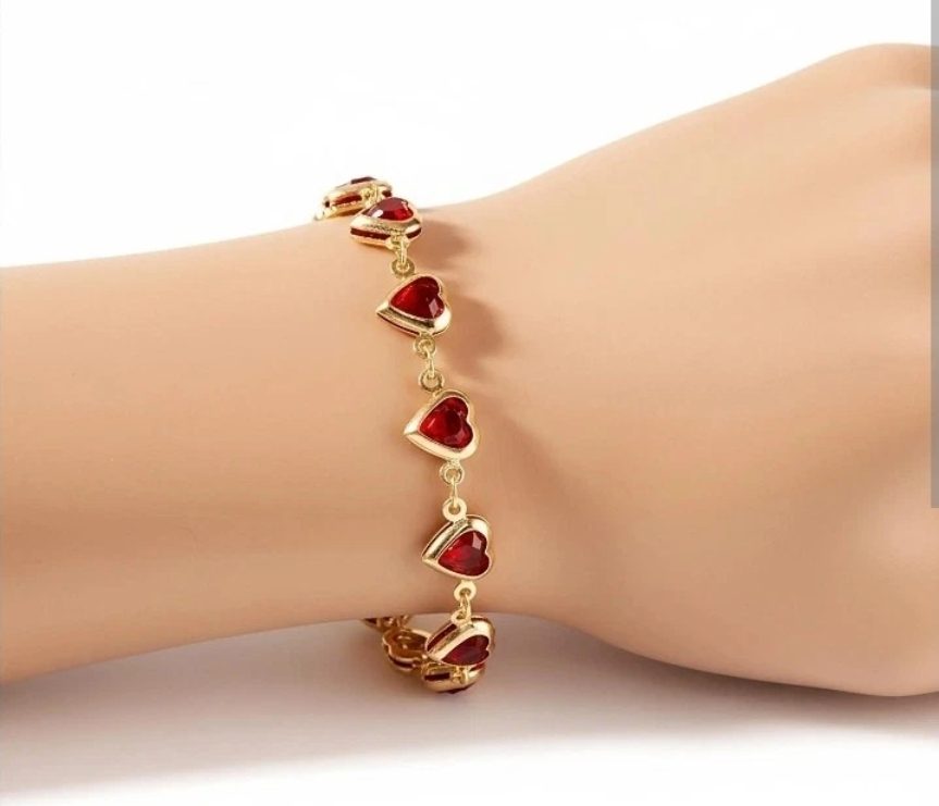 gold-tone heart charm bracelet .