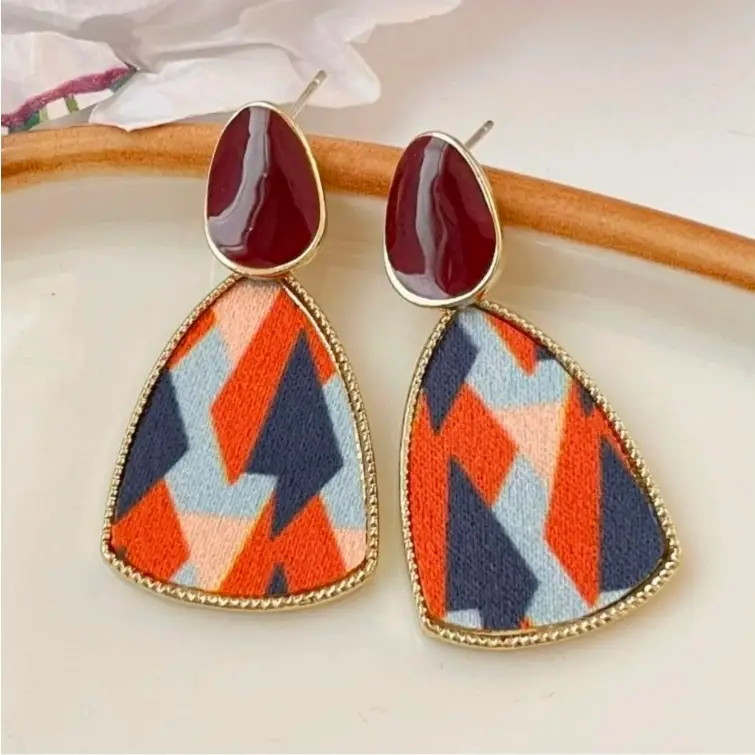 vibrant geometric patterned earrings .