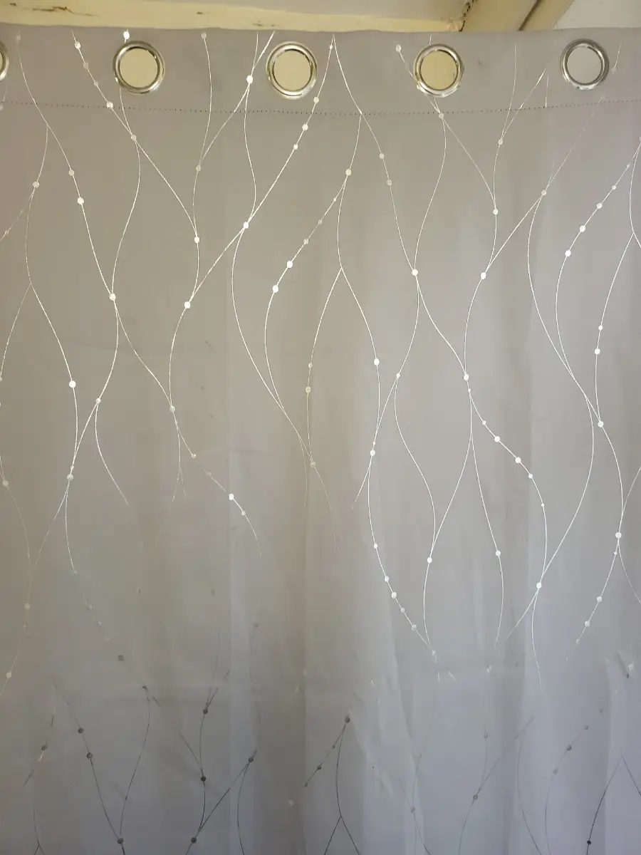 Grey eyelet blackout curtains featuring silver swirls