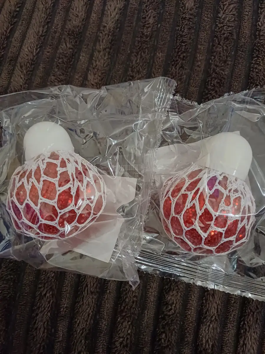 Two squishy glittery mesh balls