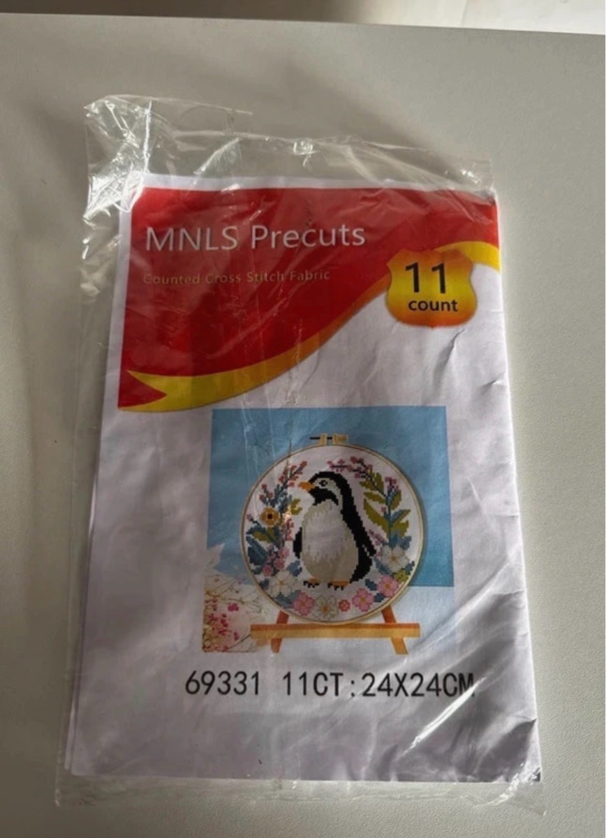 A Gorgeous Cross Stitch Kit of A Penguin Surrounded by Pretty Flowers