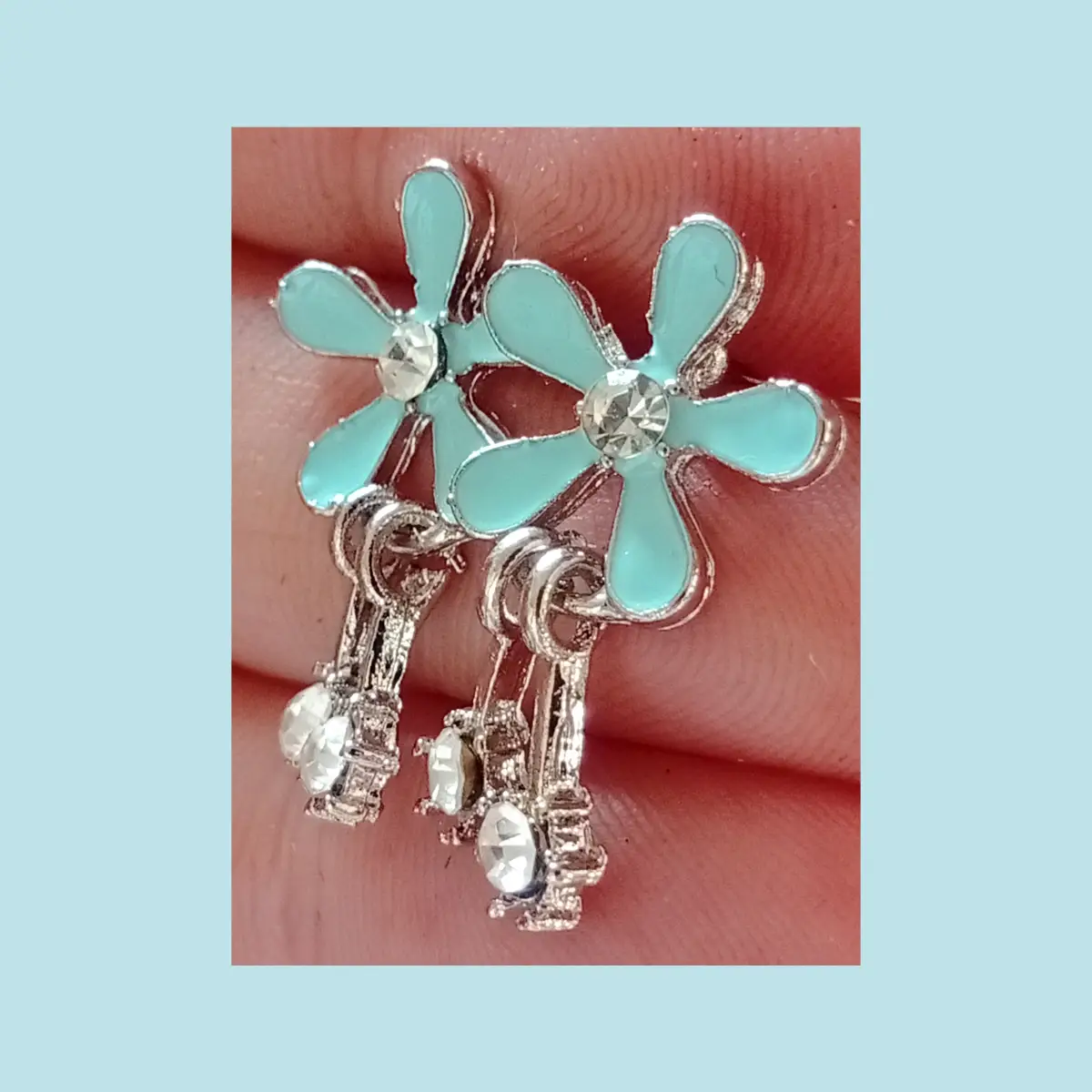 Cute pale blue flower design stud earrings.