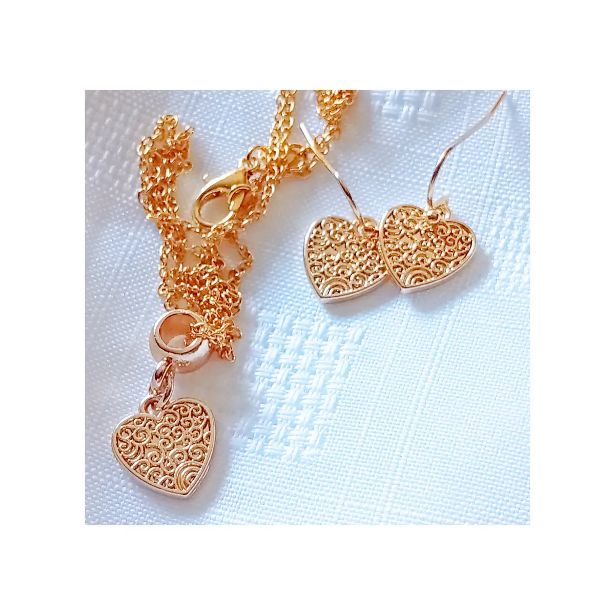 Golden metal alloy heart design earrings and necklace set.