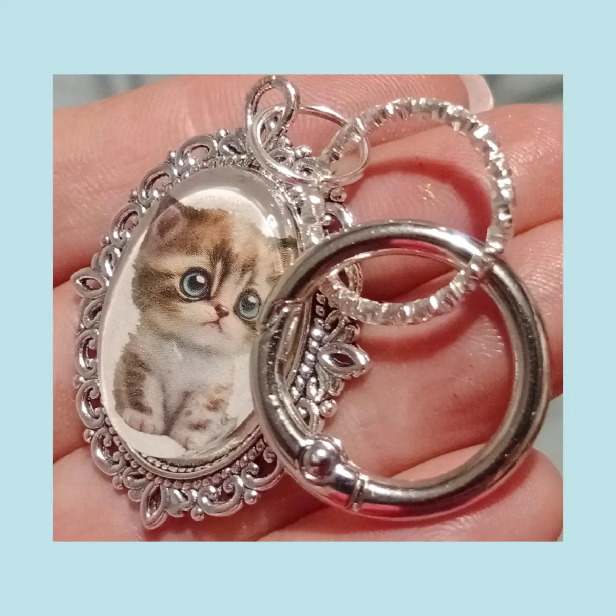 Cute tabby kitten glass cabochon keyring. Cartoon manga big blue eyes style.