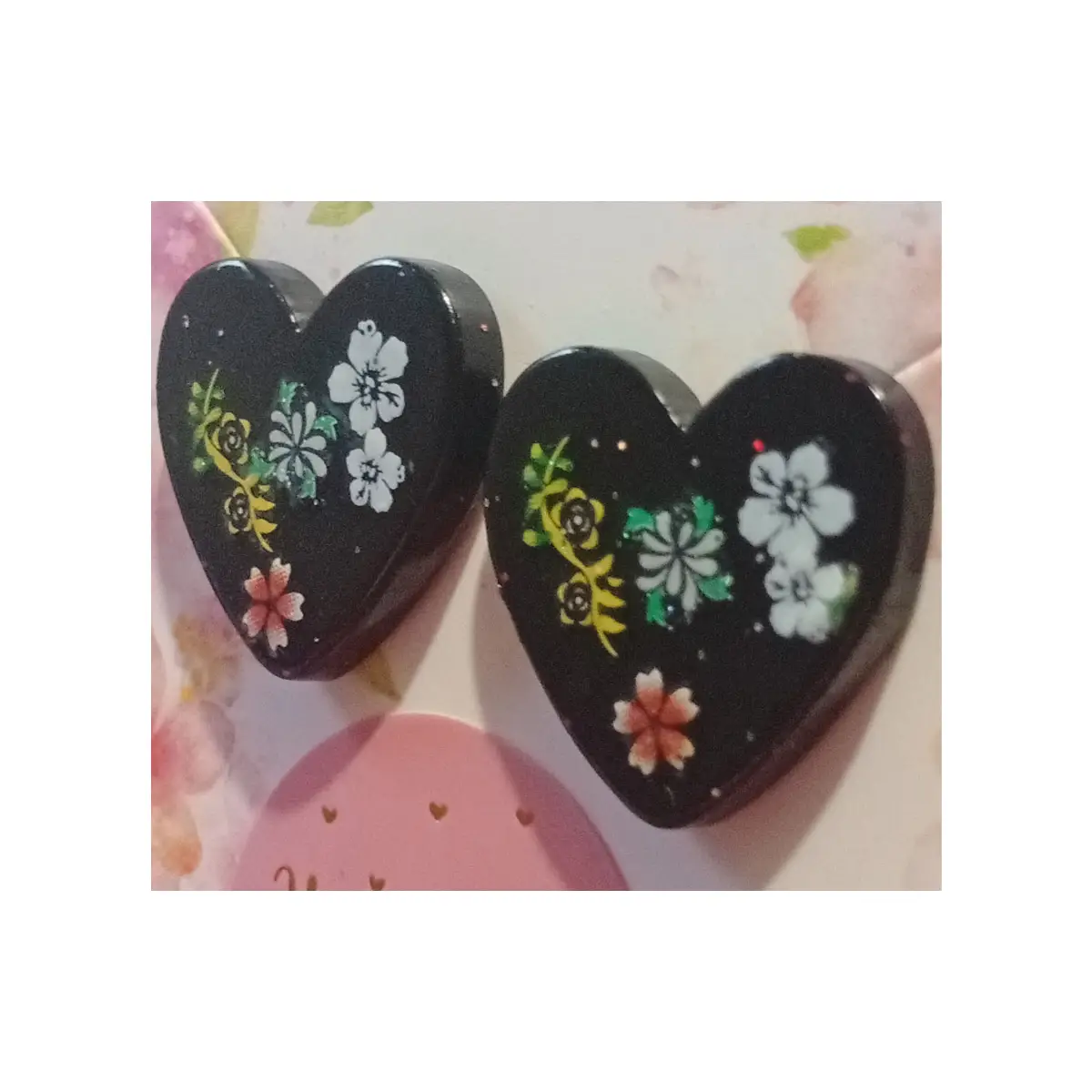 Hand made black heart shaped earrings with floral design.