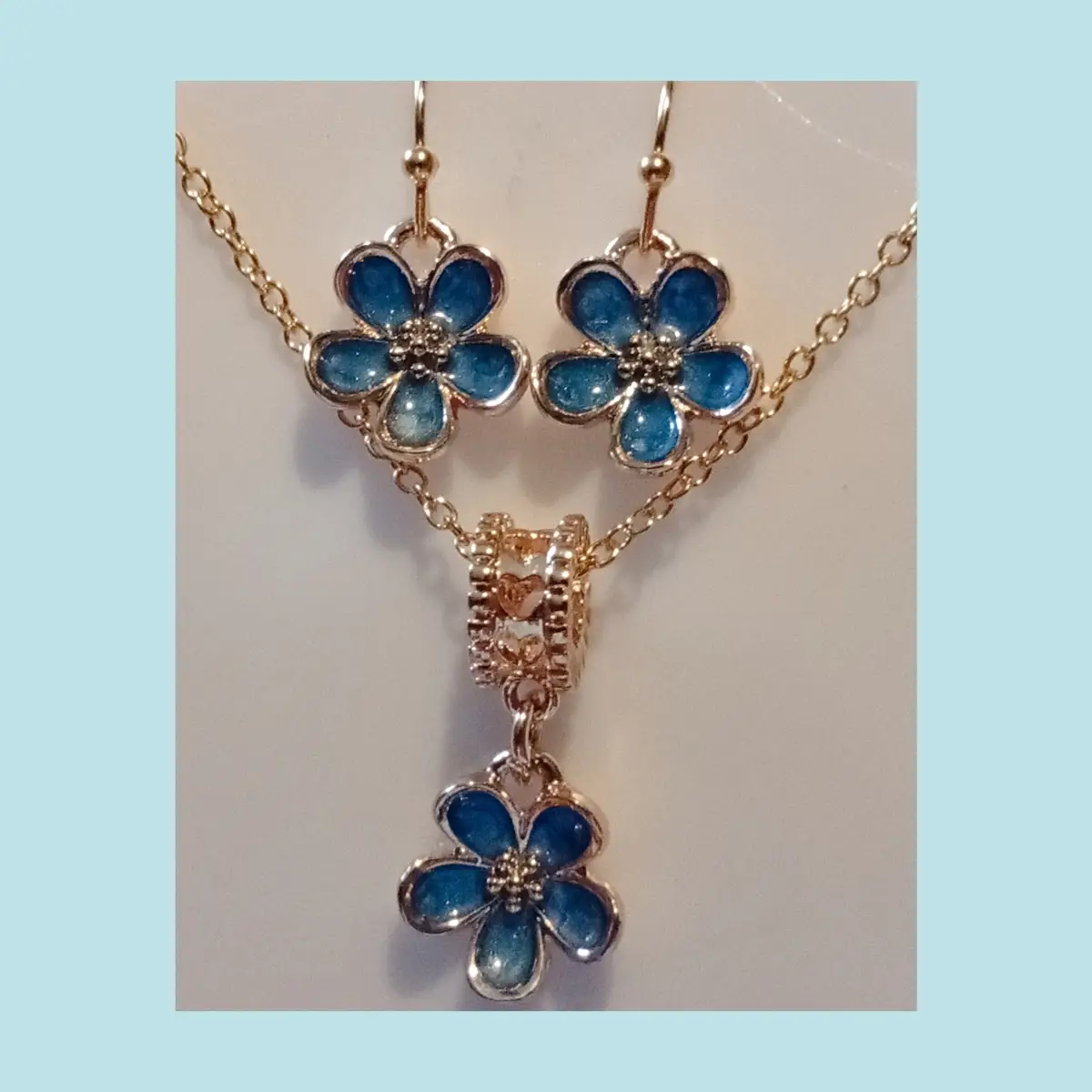 Beautiful alloy metal forget me not style earrings and necklace set.