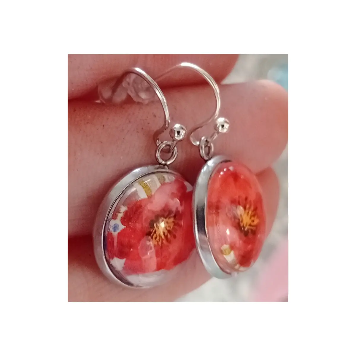Glass cabochon design earrings with red flowers.