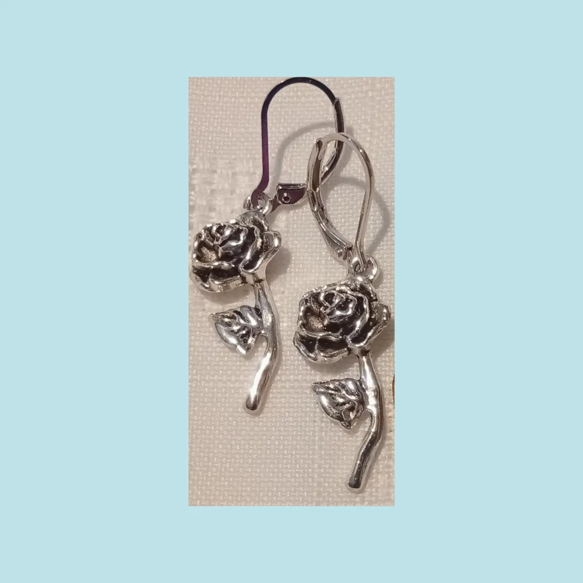 Beautiful silvery metal alloy roses design earrings. Boxed.