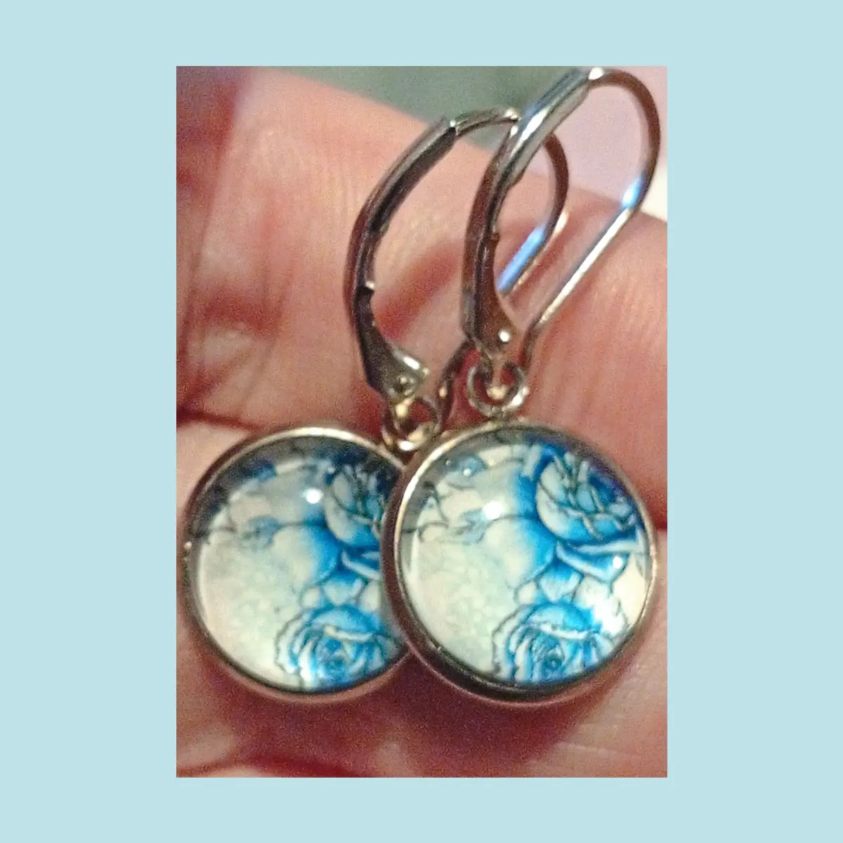 Glass cabochon blue and white floral design earrings.