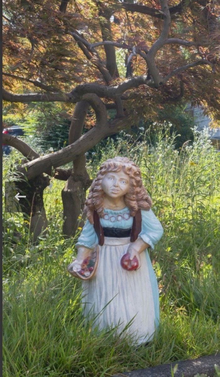 Vintage catanai girl holding apples garden statue