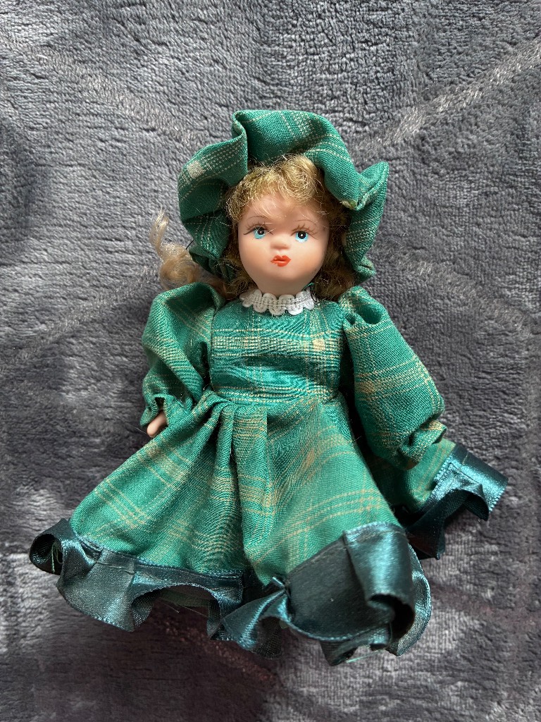 Vintage Small Porcelain Doll, With Blue Eyes, Curly Hair And Green Dress