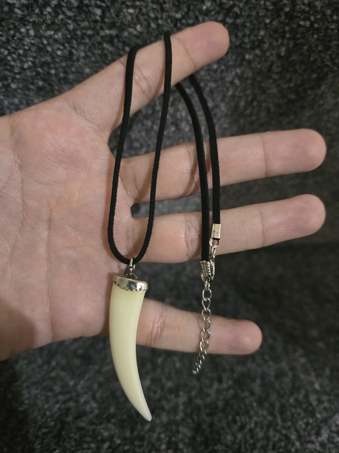 Stylish faux tooth/tusk pendant necklace with a black cord and silver-colour metal chain included