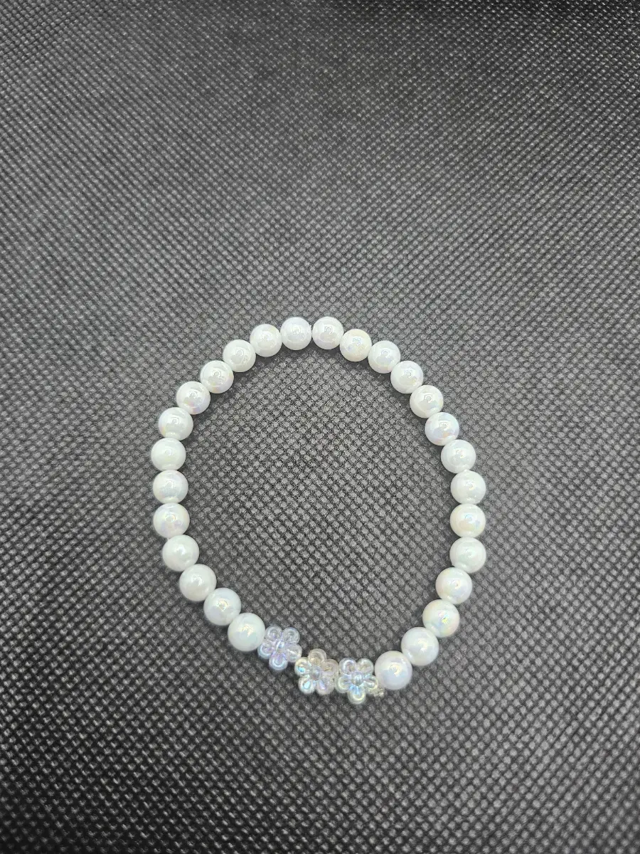 White iridescent bracelet with clear flowers