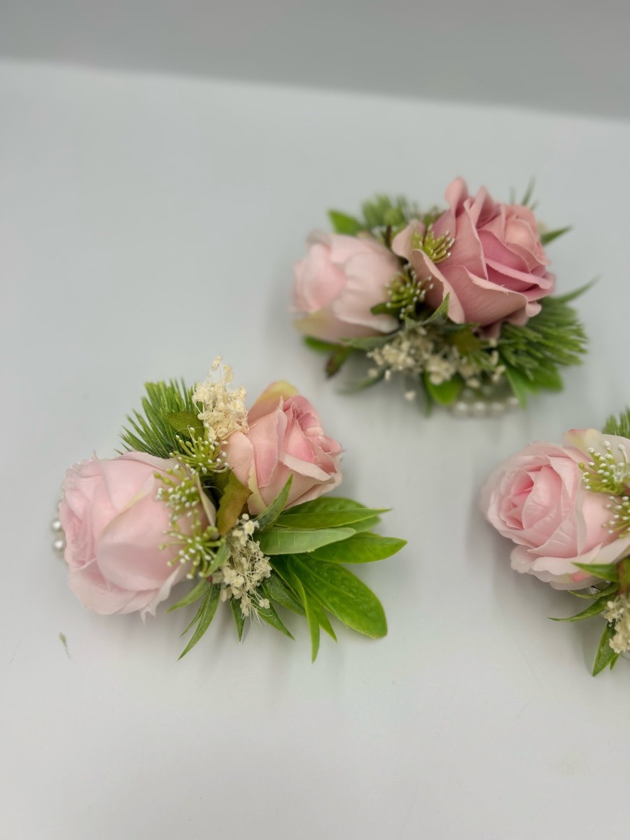 Three wrist corsages pink and sage