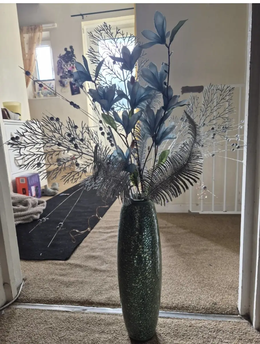 vase with artificial flowers and lights