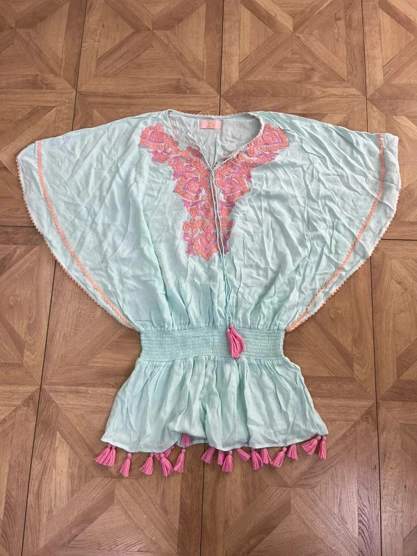 Jasmine Brooke pastel boho-style embroidered top with tassels and a cinched waist