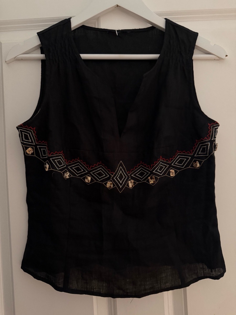 Black blouse with red and white geometric embroidery