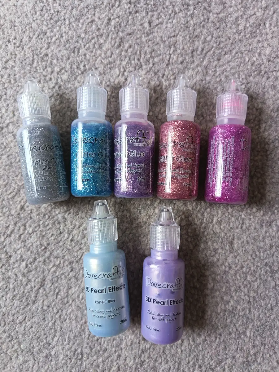 7 bottles of dove craft glitter glue and pearl effects