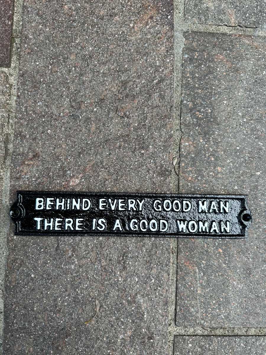 Behind every good man cast iron sign
