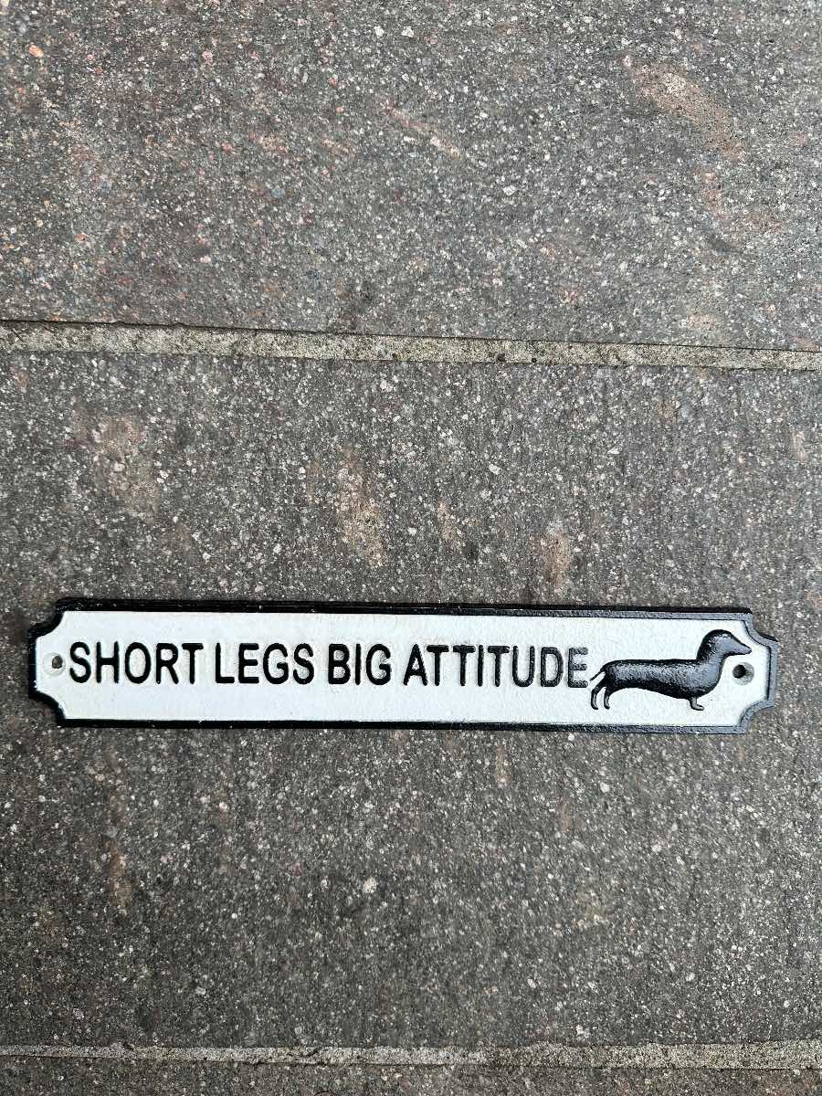 Short legs big attitude cast iron sign
