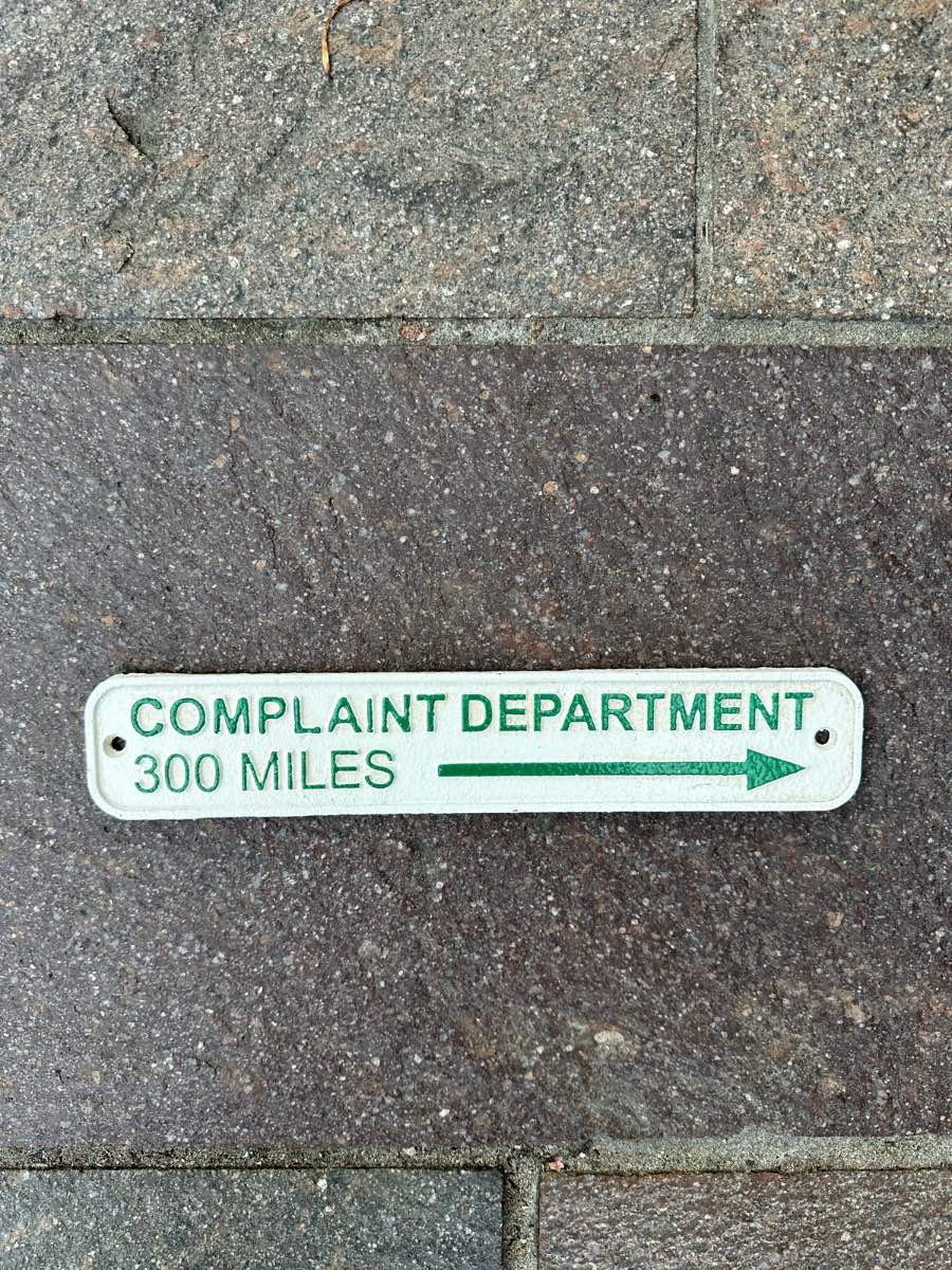 Complaint department 300 miles cast iron sign