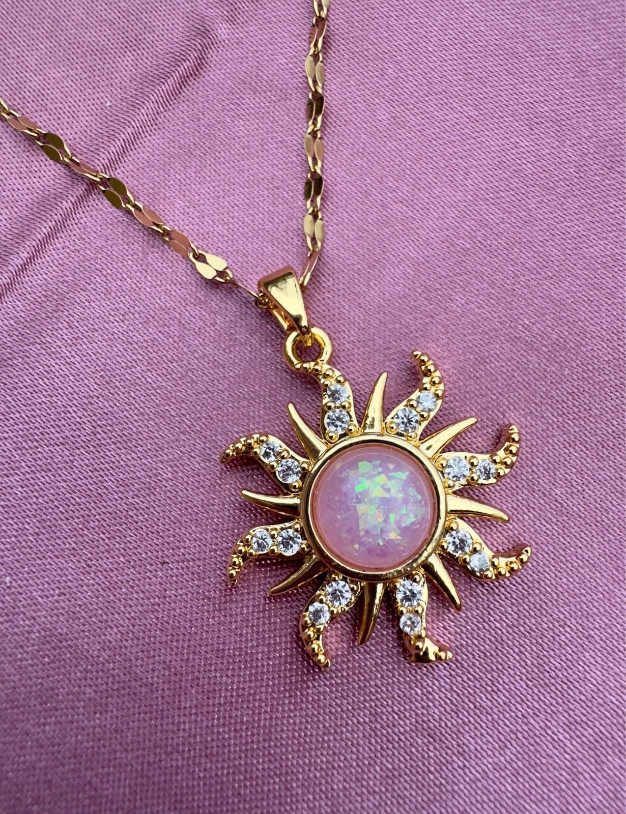 Gold plated necklace with sun inspired pendant and faux pink opal