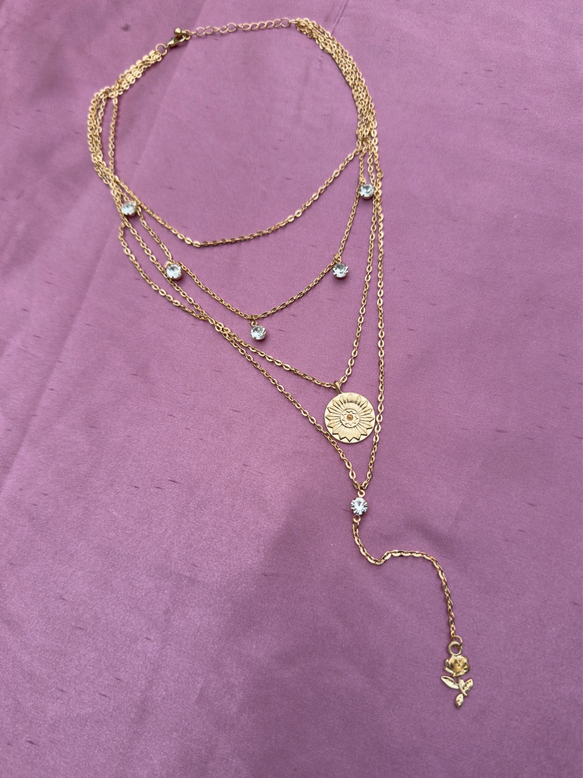 Multi layered necklace with central pendant