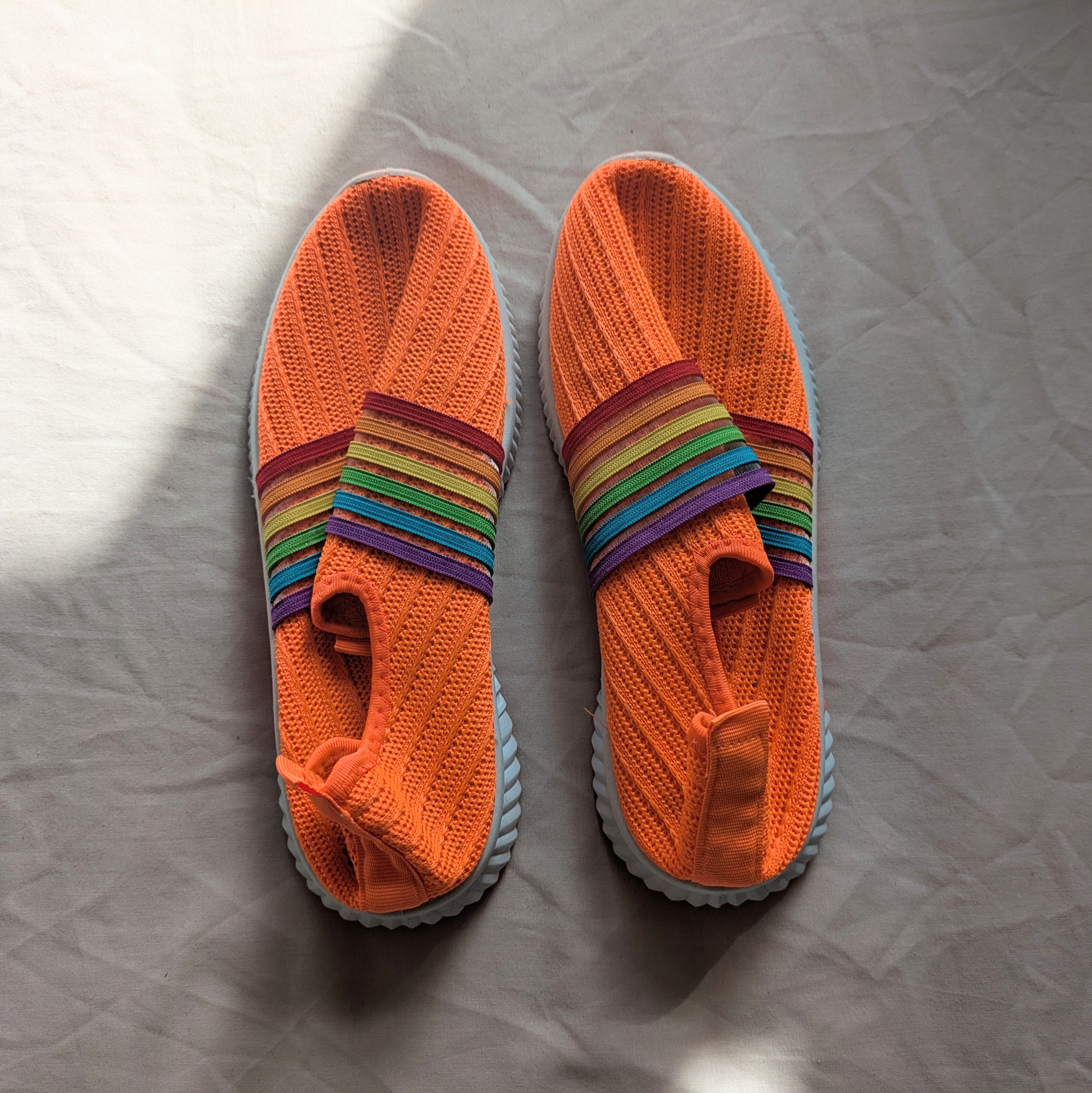 Quirky colourful rainbow neon orange women's machine washable trainers.