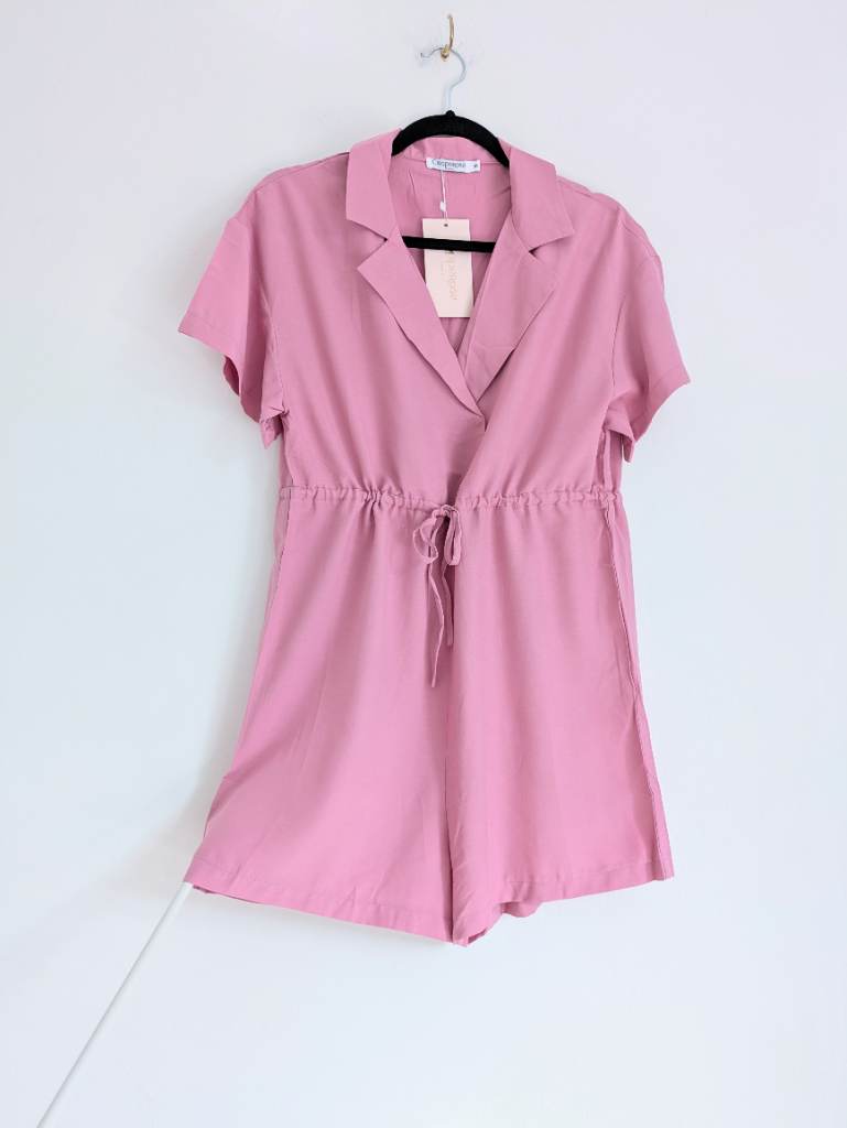 Pink minimalist playsuit with lapel collar, snap button
