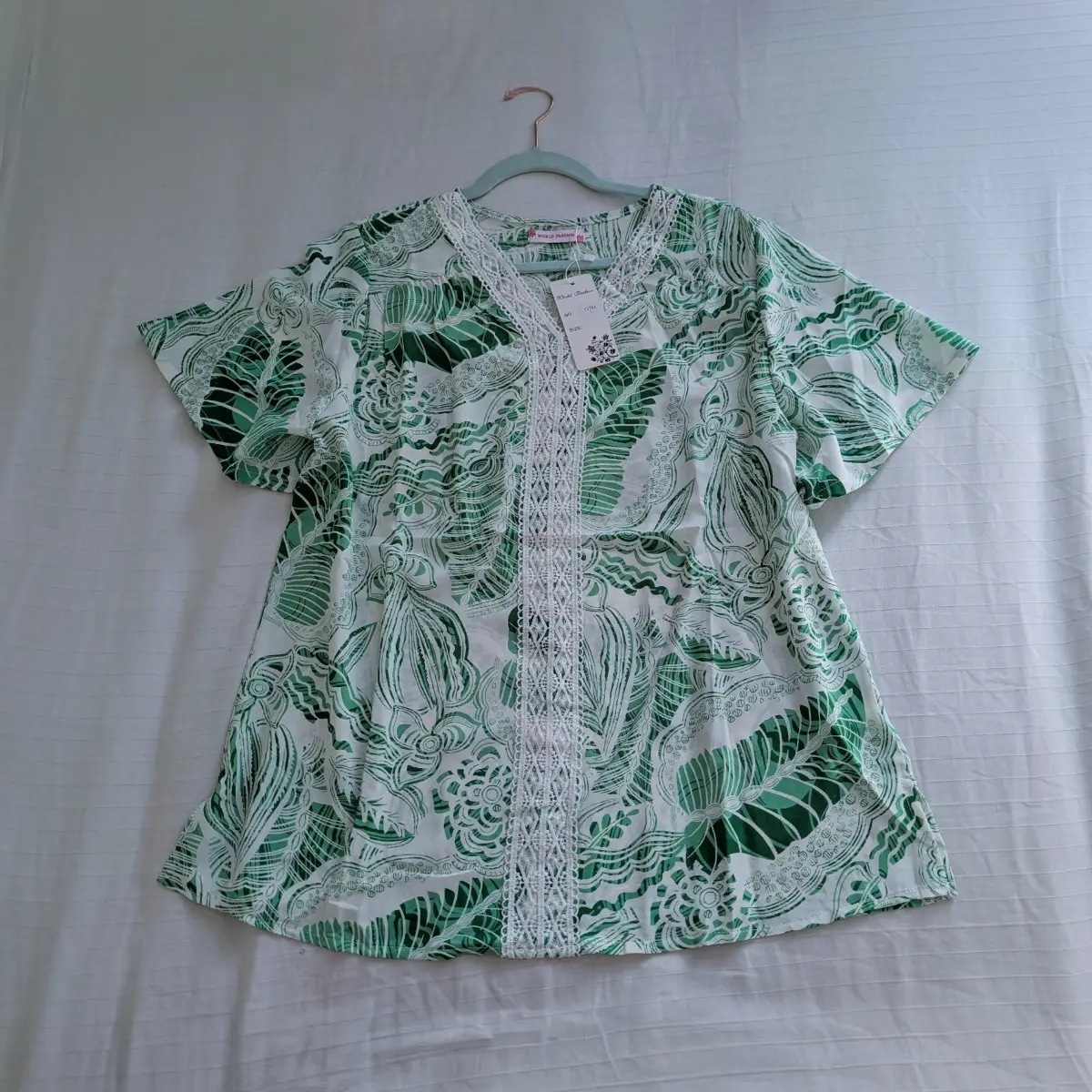 Green and white leaf print flutter sleeve blouse with vertical crochet trim down the middle New
