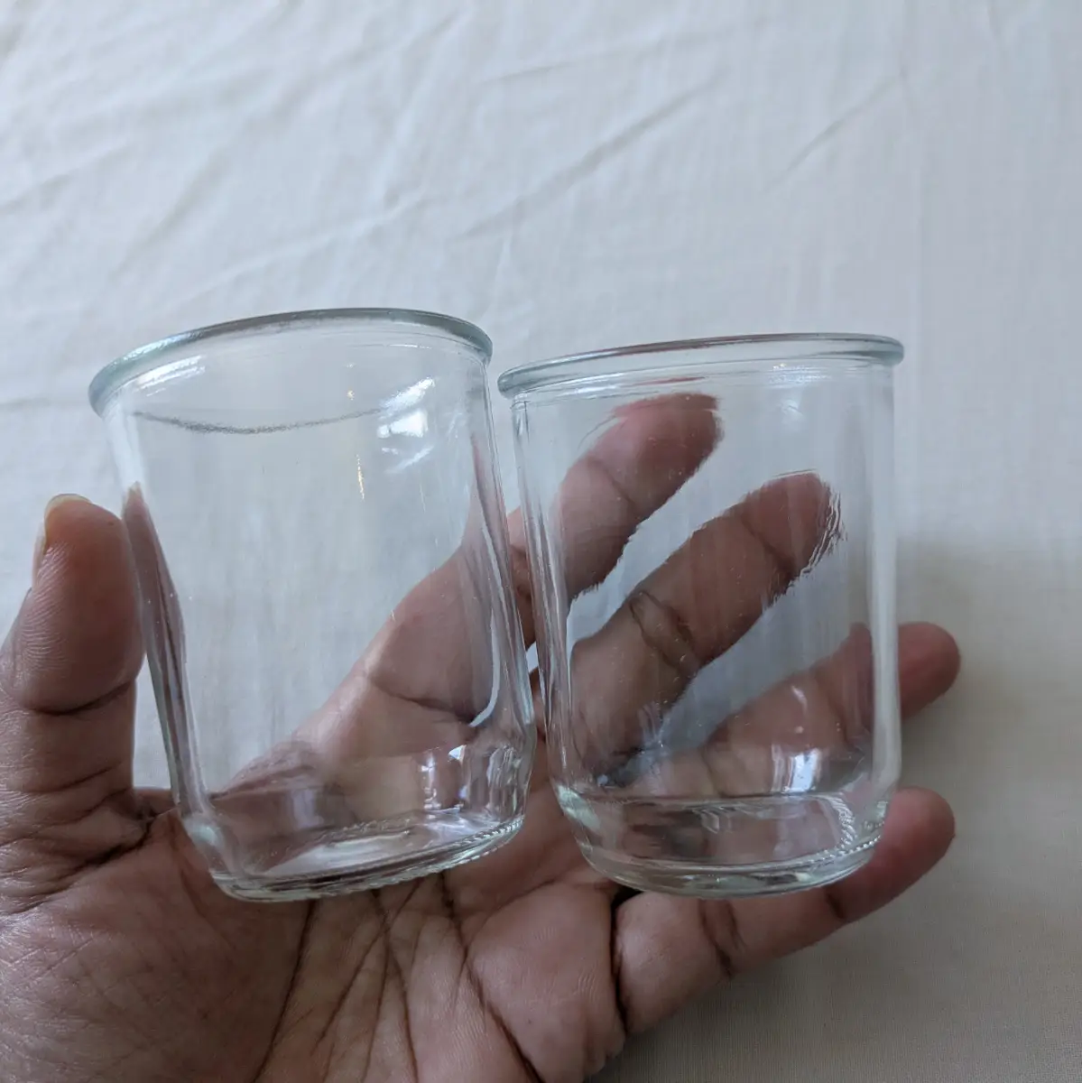 Two thick glass dessert pots, storage, moulds, mini vases, bell cloches etc