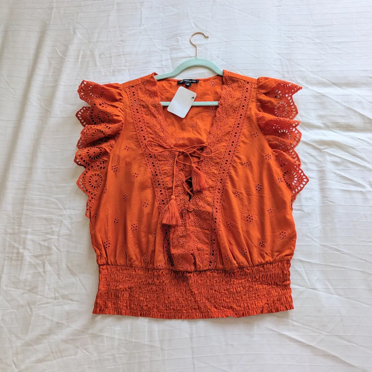 Orange broderie anglaise frilly summer lace up front blouse with tassels and smocking
