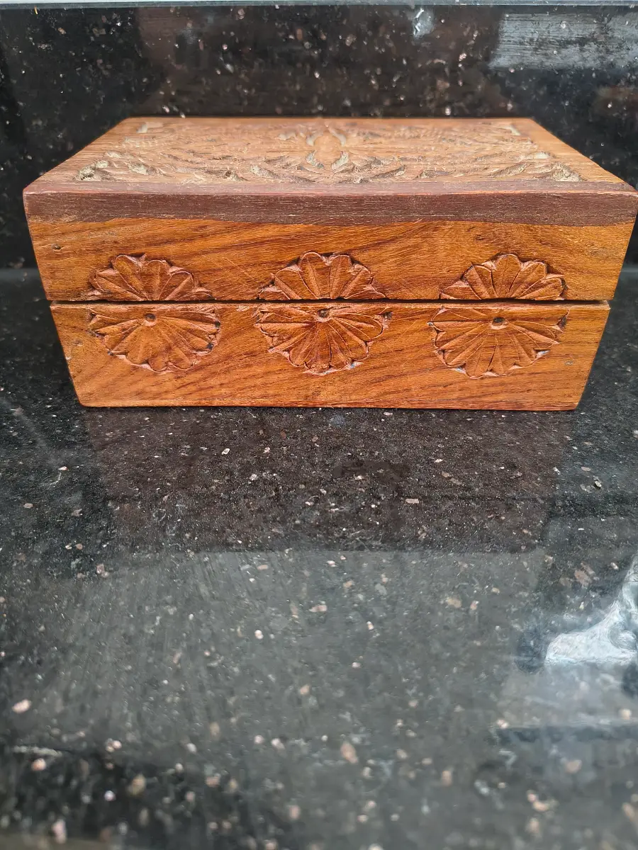 Hand carved wooden box with hinged lid