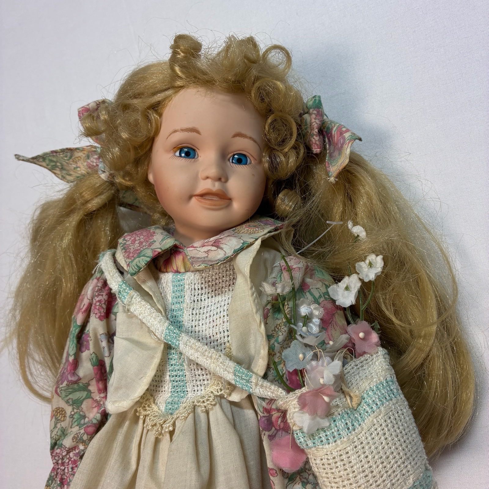 Vintage blonde hair, blue eyed Doll With Bag And Flowers.