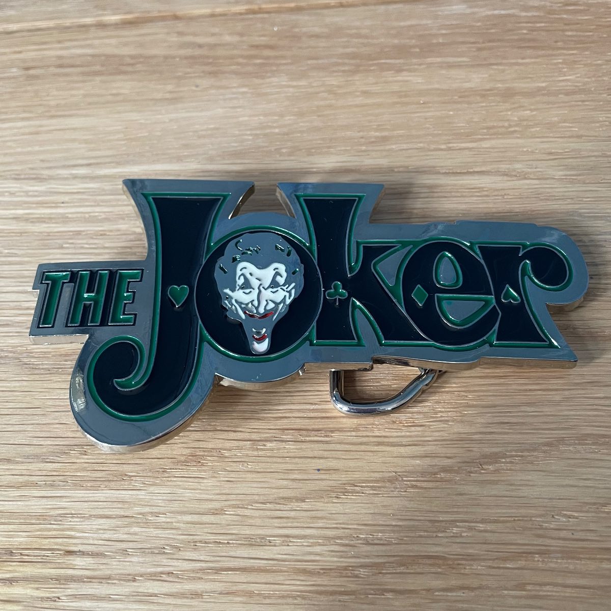 The joker belt buckle unisex black, green and silver.